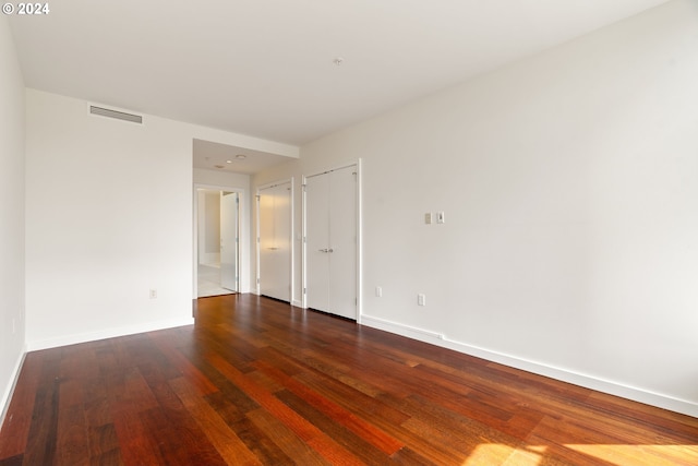 spare room with dark hardwood / wood-style flooring