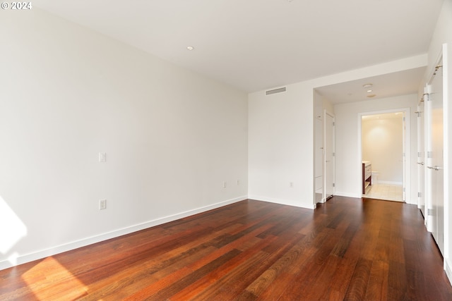 unfurnished room with dark hardwood / wood-style floors