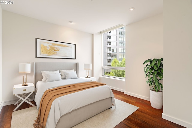 bedroom with dark wood-type flooring