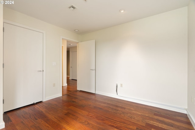 unfurnished bedroom with hardwood / wood-style floors