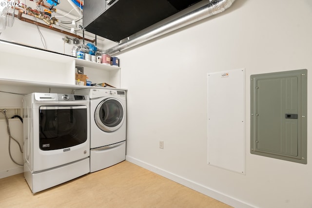 clothes washing area featuring washer and dryer and electric panel