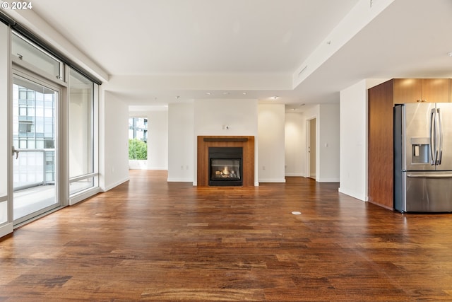 unfurnished living room featuring dark hardwood / wood-style floors and a fireplace