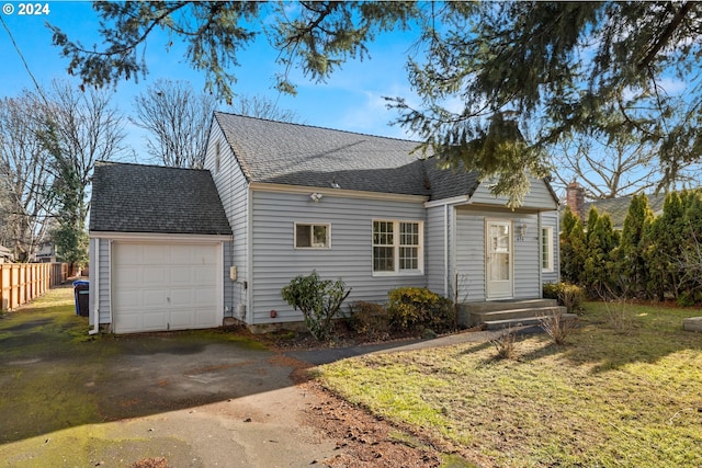 view of front of property featuring a front yard and a garage