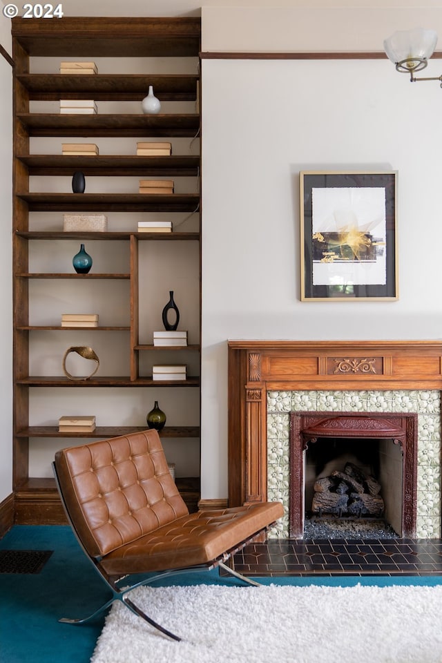 unfurnished room featuring a tile fireplace