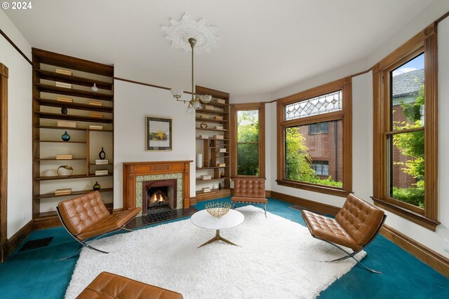726 NW 22nd Ave, Portland, OR 97210 - living room with a high end fireplace, a notable chandelier, baseboards, and built in shelves