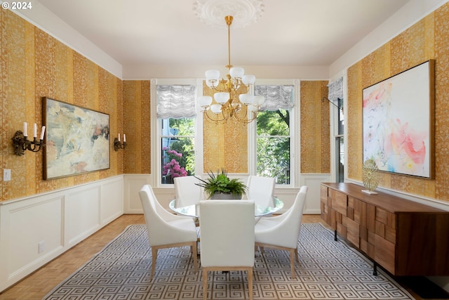 726 NW 22nd Ave, Portland, OR 97210 - dining space featuring wallpapered walls, an inviting chandelier, wainscoting, and plenty of natural light