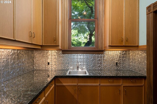726 NW 22nd Ave, Portland, OR 97210 - kitchen featuring backsplash, a sink, and dark stone counters