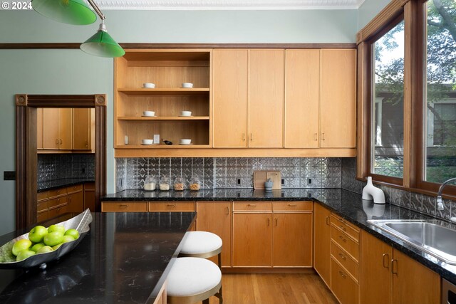 726 NW 22nd Ave, Portland, OR 97210 - kitchen with backsplash, a sink, open shelves, light wood-type flooring, and dark stone countertops