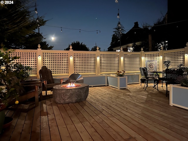 deck at twilight with an outdoor fire pit