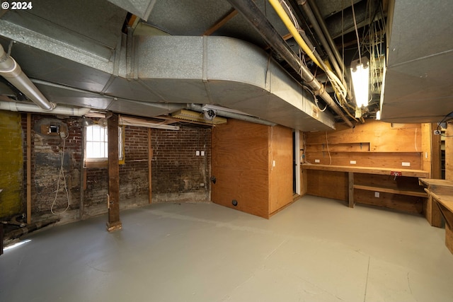 726 NW 22nd Ave, Portland, OR 97210 - basement with a workshop area and brick wall