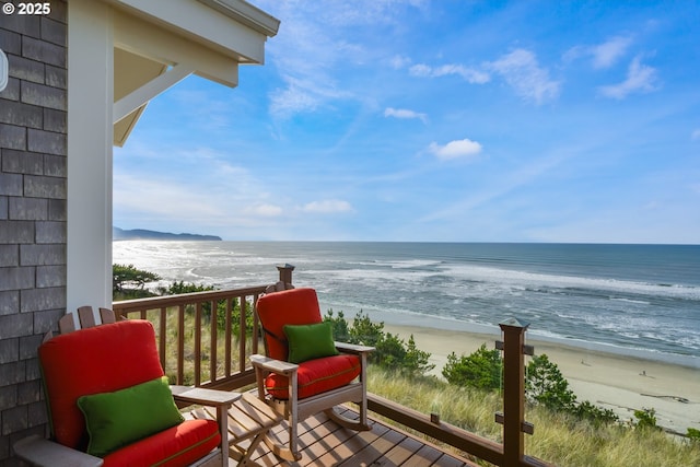 balcony featuring a water view and a view of the beach