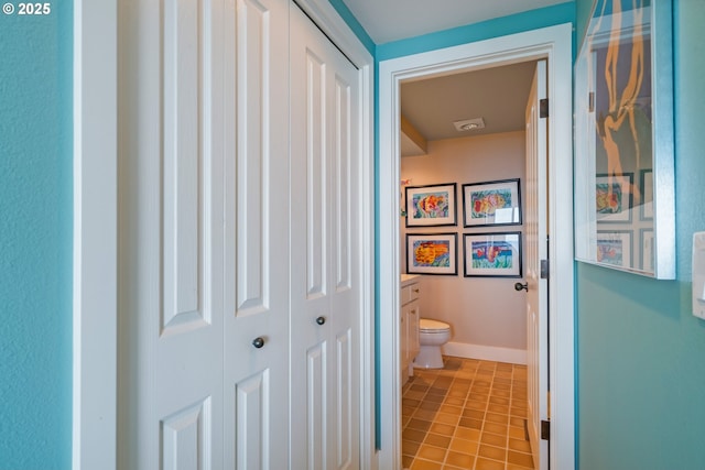 bathroom featuring tile patterned flooring, vanity, and toilet