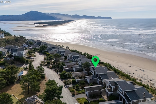 birds eye view of property with a beach view and a water and mountain view