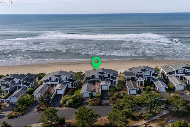 drone / aerial view featuring a water view and a beach view