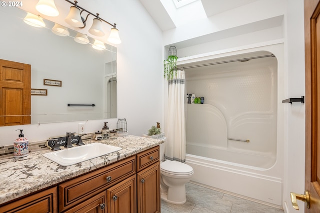 full bathroom featuring a skylight, vanity, shower / bath combo with shower curtain, tile patterned flooring, and toilet