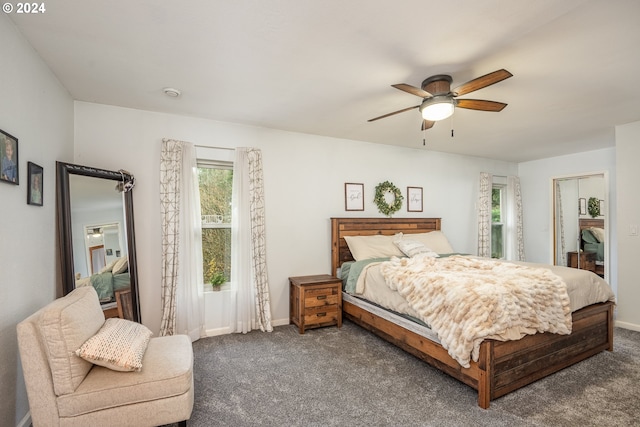 carpeted bedroom featuring ceiling fan and a closet