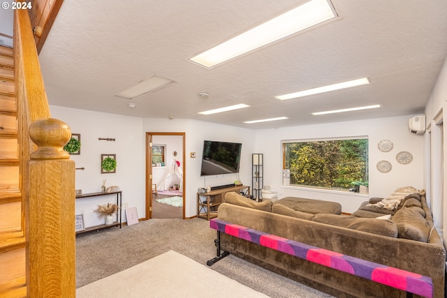 carpeted living room featuring a textured ceiling and a wall unit AC