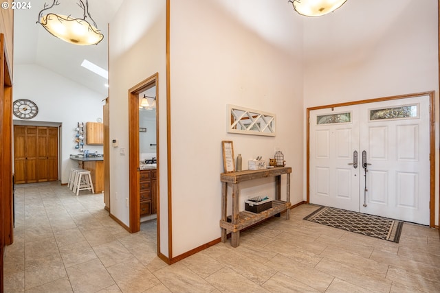 foyer featuring high vaulted ceiling