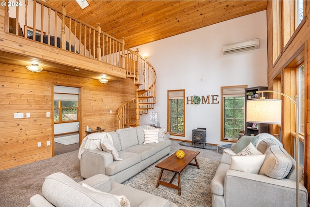 living room with carpet flooring, a wood stove, wooden ceiling, a high ceiling, and an AC wall unit