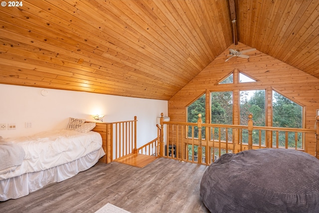 bedroom with vaulted ceiling with beams, wood walls, wood-type flooring, and wooden ceiling