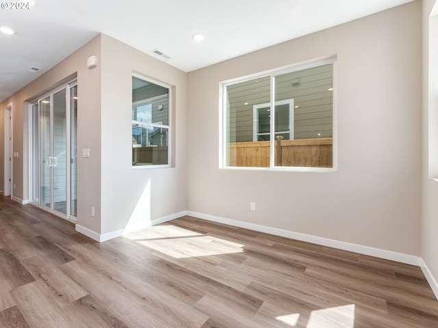 unfurnished room with light hardwood / wood-style flooring