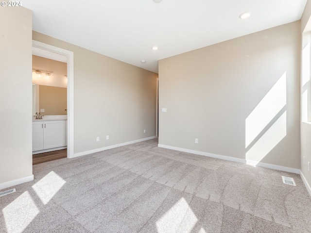 empty room with light colored carpet