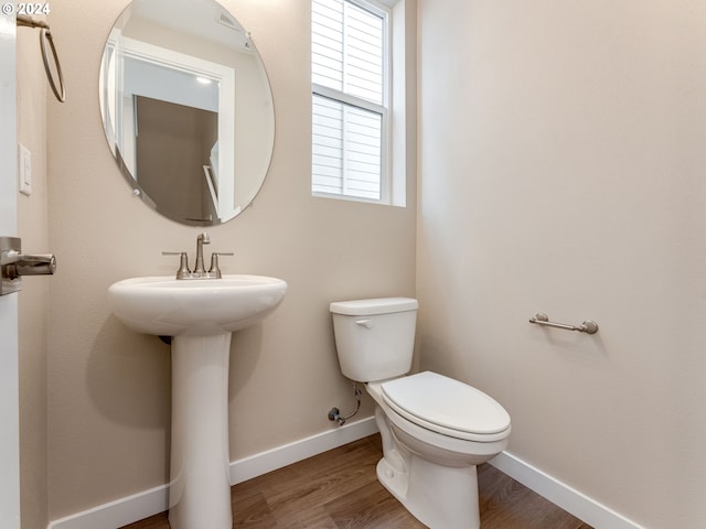 bathroom with sink, toilet, and hardwood / wood-style flooring