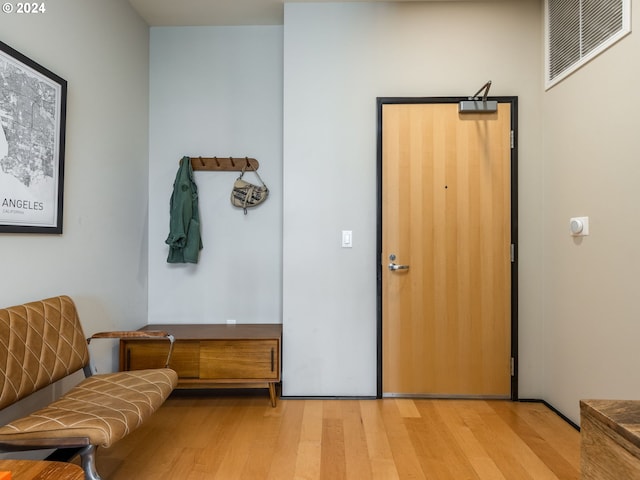 sitting room featuring visible vents and light wood-style flooring