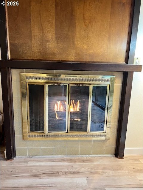 room details with a fireplace and hardwood / wood-style flooring