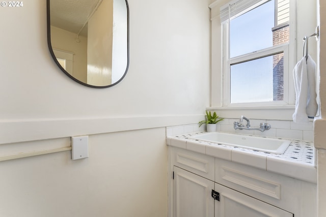 bathroom featuring plenty of natural light and vanity