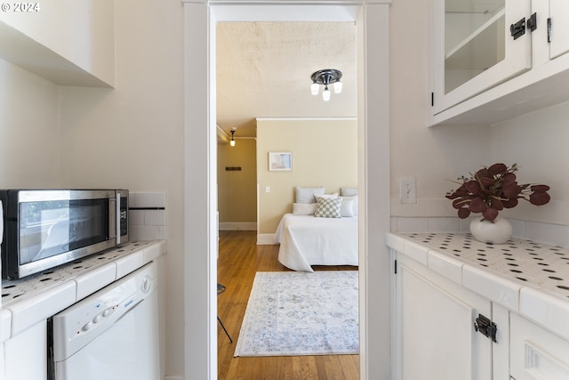 bedroom with crown molding and light wood-type flooring