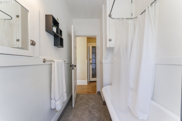 bathroom with hardwood / wood-style floors and shower / tub combo