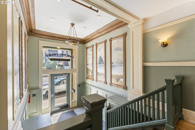 interior space with crown molding, a healthy amount of sunlight, and hardwood / wood-style flooring