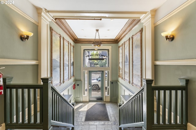 entryway featuring crown molding