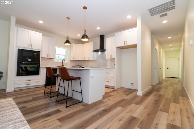 6018 Little Woahink Dr, Florence, OR 97439 - kitchen featuring wall chimney exhaust hood, black appliances, white cabinets, tasteful backsplash, and recessed lighting