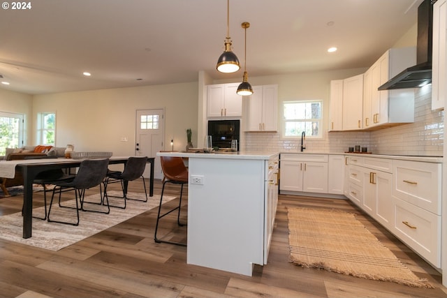 6018 Little Woahink Dr, Florence, OR 97439 - kitchen with wall chimney exhaust hood, a kitchen island, healthy amount of natural light, and recessed lighting