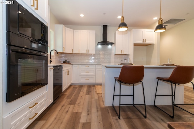 6018 Little Woahink Dr, Florence, OR 97439 - kitchen featuring black appliances, wall chimney exhaust hood, light wood-style floors, white cabinets, and a breakfast bar