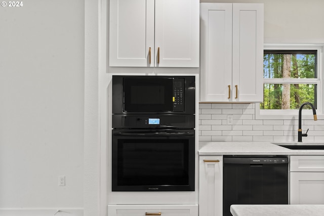 6018 Little Woahink Dr, Florence, OR 97439 - kitchen with black appliances, white cabinetry, decorative backsplash, and light stone counters