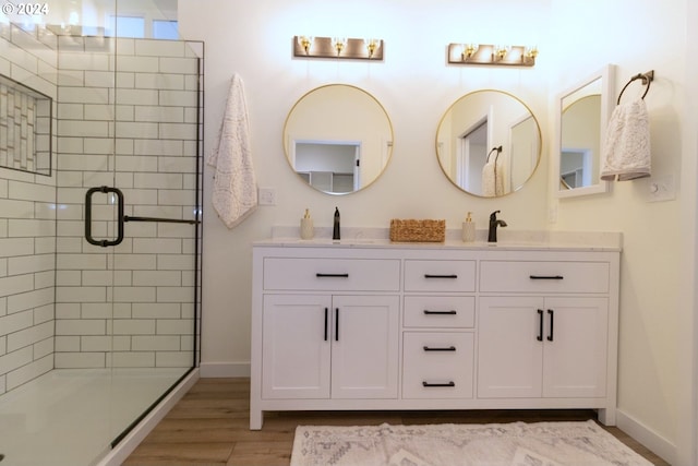 6018 Little Woahink Dr, Florence, OR 97439 - bathroom featuring double vanity, a stall shower, and wood finished floors