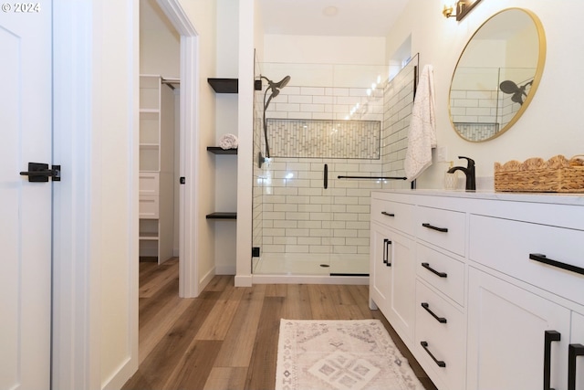 6018 Little Woahink Dr, Florence, OR 97439 - full bathroom featuring a stall shower, wood finished floors, vanity, and a spacious closet