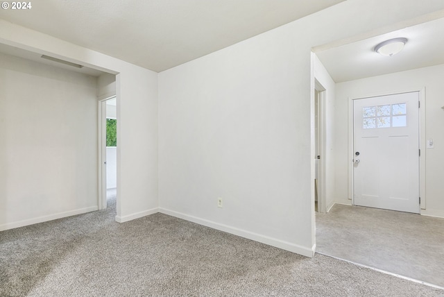 foyer entrance with carpet flooring