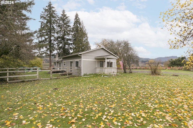 exterior space featuring a lawn and a deck with mountain view