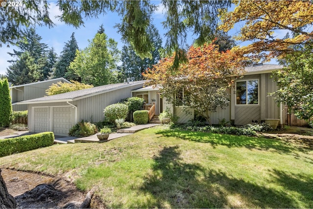 view of front of property with a front yard and a garage