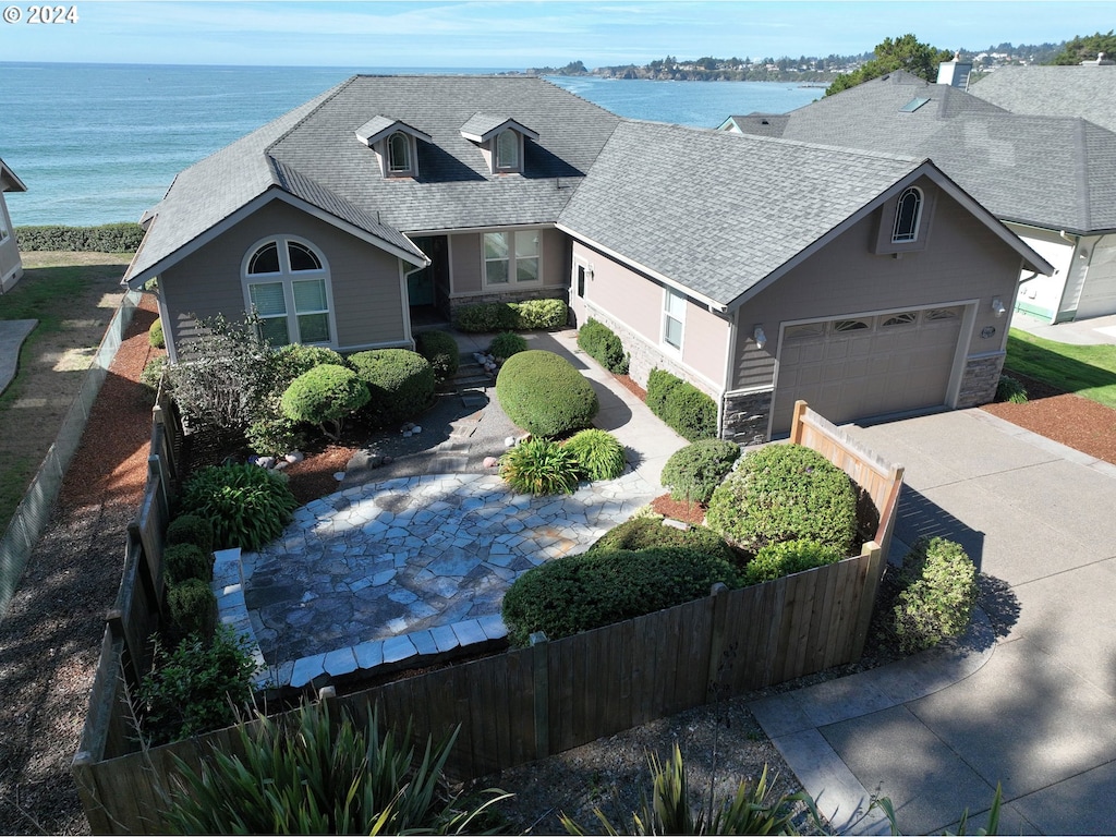 view of front of property featuring a water view and a garage