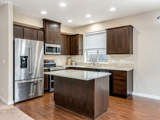 kitchen featuring a kitchen island, dark hardwood / wood-style flooring, sink, and appliances with stainless steel finishes