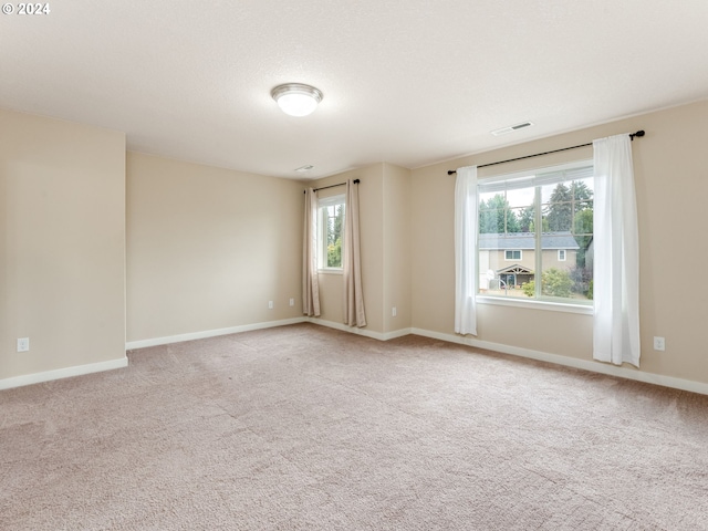 unfurnished room with light carpet