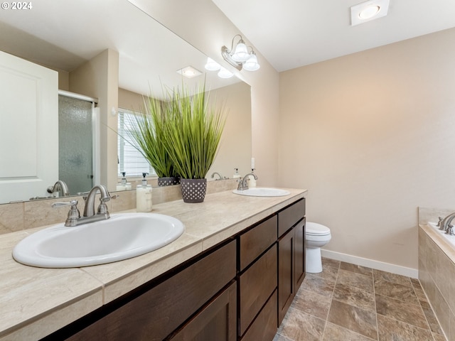 full bathroom featuring vanity, toilet, and shower with separate bathtub