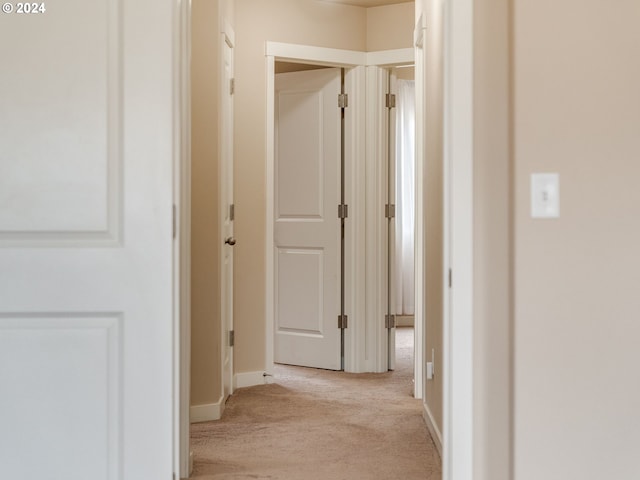 hall with light colored carpet