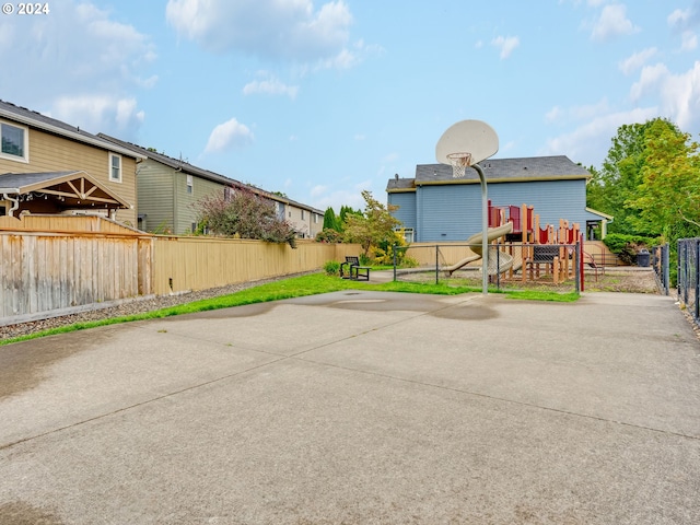 exterior space with a playground and basketball court