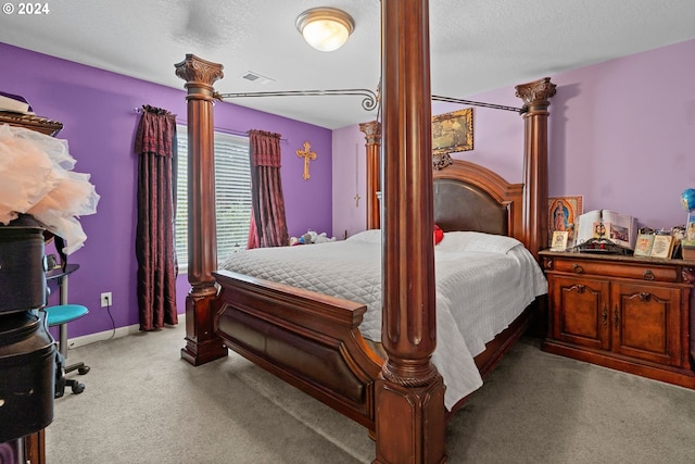 carpeted bedroom featuring a textured ceiling